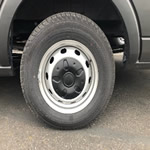 A vehicle tire on a dirty road with proper suspension