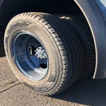 A close up of a tire on a truck image in color.